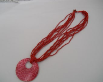 Red Beaded necklace with red/white plastic pendant