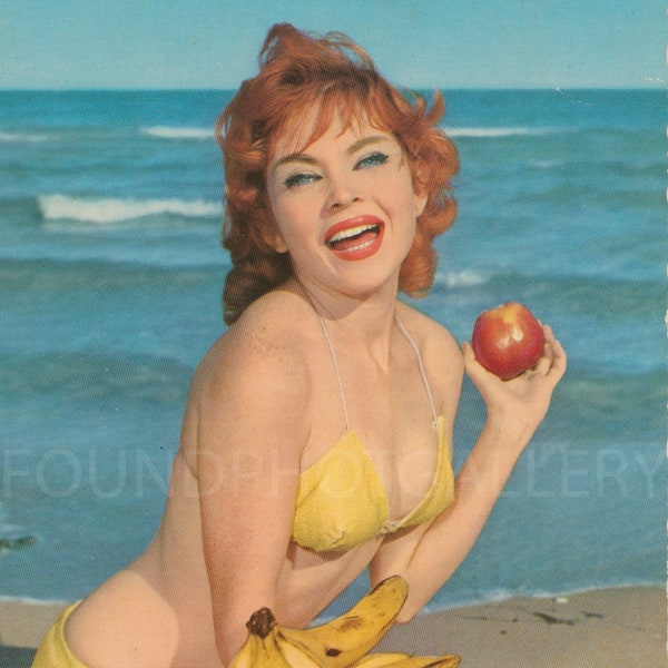 Eat Apples & Bananas by the Sea With This Glamorous Red Head Pin Up In a Yellow Bikini Sitting on the Sand, Vintage Color Photo Postcard