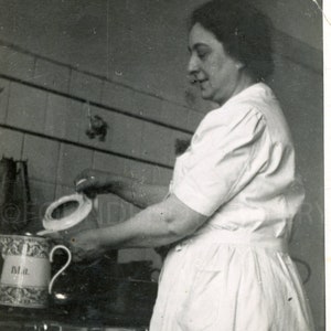 Woman Brewing Coffee or Tea in Enamel Pot on Vintage Stove, Vintage Photo