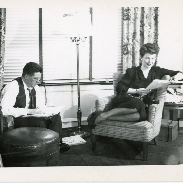 Couple Relaxing on Sunday Morning in the Living Room Reading the Newspaper, Vintage Photo