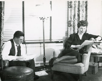 Couple Relaxing on Sunday Morning in the Living Room Reading the Newspaper, Vintage Photo