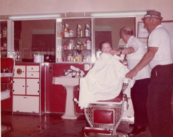 Rosy Cheeked Boy With Dad Getting First Haircut in Red Chair at Barbershop, Vintage Photo, Color Snapshot, Feb 1964