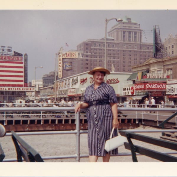 American Flag on the Atlantic City Boardwalk with Woman Dressed in Pinstripe Dress and Straw Hat