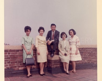 Well Dressed Asian Tourists Posed against Brick Wall for Photo Portrait, Vintage Photo, Color Snapshot