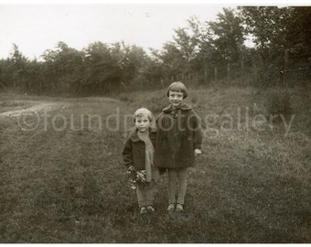 Two Young Girls in Coats Standing in a Field holding Flowers and Posiing for a Picture, Vintage Photo Print, Black and White Photo