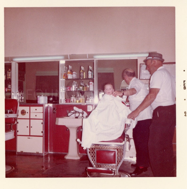 Rosy Cheeked Boy With Dad Getting First Haircut in Red Chair at Barbershop, Vintage Photo, Color Snapshot, Feb 1964 image 1