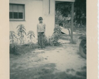 Shy Young Boy Standing in Front of a Rural Building in a Warm Climate, Vintage Photo, Snapshot,