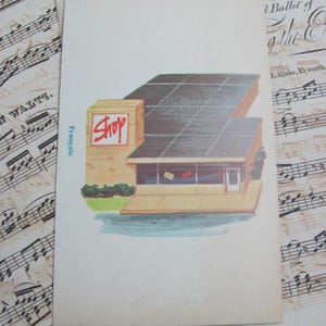 May include: Vintage postcard illustration of a shop with a flat roof and a sign that reads "Shop" in red. The building has a tan facade, a dark roof, and a glass storefront. The postcard is on a background of sheet music.