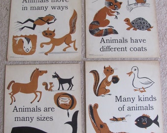 May include: Four vintage educational posters with illustrations of animals. The posters have black and brown illustrations on a white background. The text on the posters reads: "Animals move in many ways", "Animals have different coats", "Animals are many sizes", and "Many kinds of animals".
