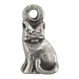 May include: A small, silver-colored cat charm with a loop at the top for attaching to a necklace or bracelet. The charm is detailed with the cat's features, including its ears, face, and body. The cat is sitting upright.