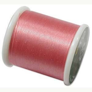 May include: A spool of pink thread with a white plastic bobbin.