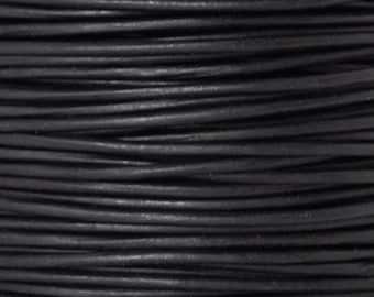 May include: A spool of black leather cord. The cord is smooth and has a slight sheen.