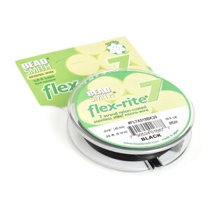 May include: A spool of black Bead Smith Flex-Rite 7 strand nylon-coated stainless steel micro-wire. The spool is labeled with the product name, size, and break strength. The text on the label reads: "Bead Smith Flex-Rite 7 strand nylon-coated stainless steel micro-wire .018" (45 mm) 30 ft (9.14 m) #FL7X018BK30 20.6 LB BREAK BLACK www.beadsmith.com made in japan"