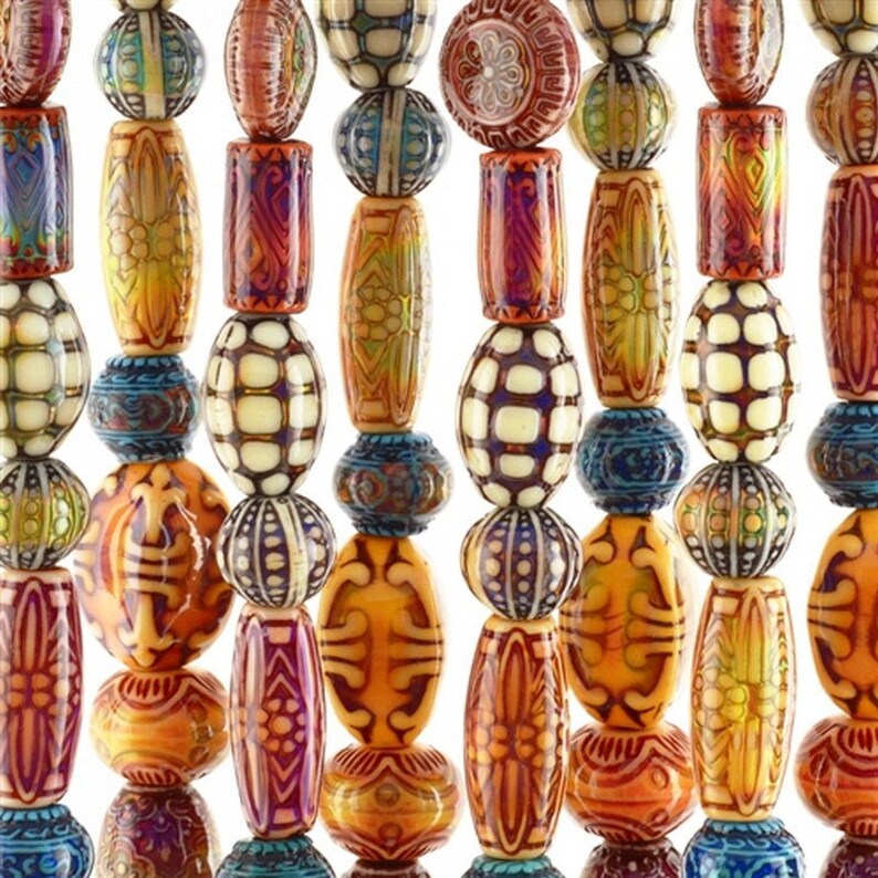 May include: A close-up of a collection of colourful beads in various shapes and sizes. The beads are strung together, showcasing a variety of patterns and colours, including orange, blue, yellow, and white. The beads have intricate designs.