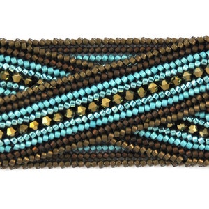 May include: A close-up of a beaded bracelet with a woven pattern in shades of brown, teal, and gold.