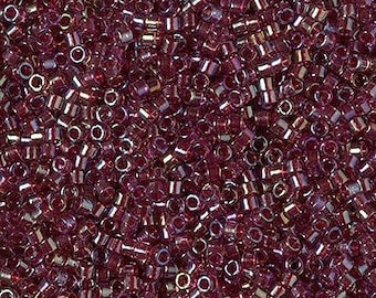 May include: A close-up view of a large quantity of small, round, iridescent purple glass beads. The beads have a metallic sheen and are perfect for jewelry making or other craft projects.