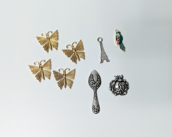Assorted findings and charms, butterflies, spoon, flower, eiffel tower, parrot