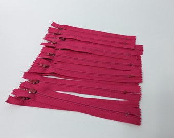 Twelve 6" bright pink zippers, YKK brand, #3 nylon zippers