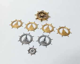 Assorted ships wheel metal brass stampings, raw brass, silver oxidized,