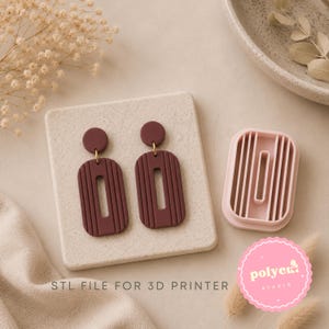 May include: A pair of dark maroon earrings with a vertical ribbed texture and a central rectangular cutout, accompanied by a light pink plastic cutter tool. The text "STL FILE FOR 3D PRINTER" is printed at the bottom of the image.