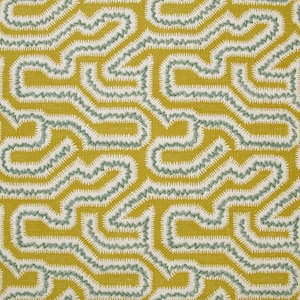 May include: Close-up of a fabric with a repeating pattern. The design features a maze-like pattern in white and teal green, set against a mustard yellow background. The fabric has a textured appearance.