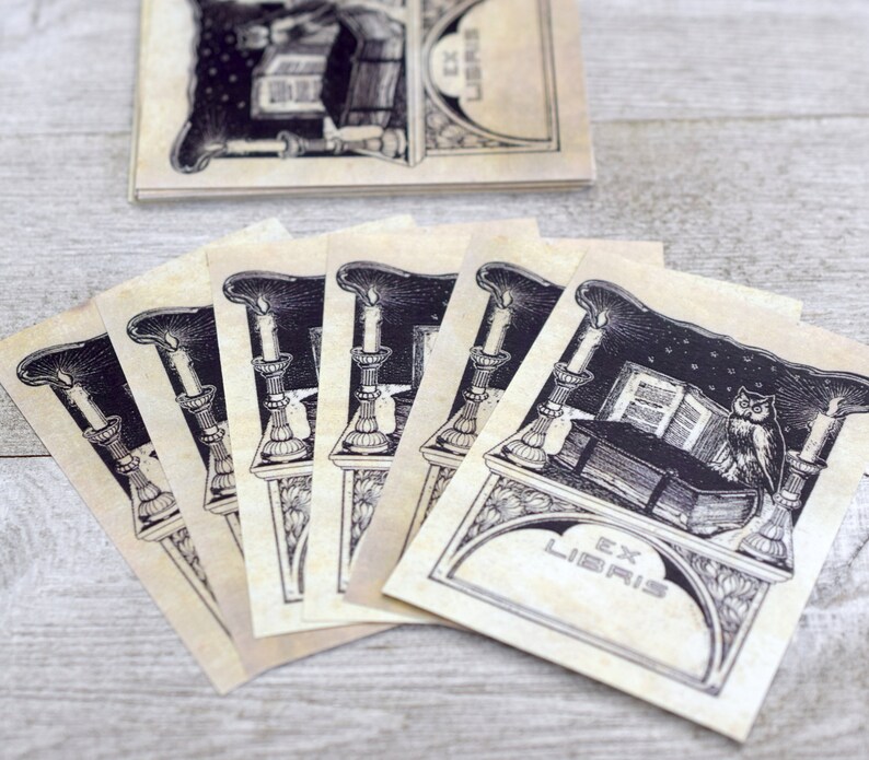 May include: A set of six vintage bookplates featuring an owl perched on a book with candles and the text "Ex Libris".