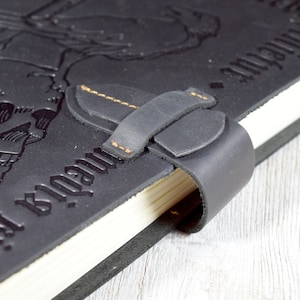 Closeup of the black leather journal strap closure