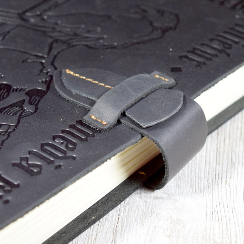 Closeup of the black leather journal strap closure
