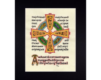 May include: A Celtic cross with intricate designs in shades of red, green, blue, and gold. The cross is surrounded by a text that reads "May the road rise up to meet you, may the wind always be at your back, may the sun shine warm on your face, and rains fall soft on your fields. And until we meet again, may God hold you in the palm of His hand."