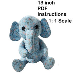 May include: A plush elephant toy, approximately 13 inches tall, in a sitting position. The elephant is covered in a light blue fabric with a floral pattern in pink and white. The image includes the text "13 inch PDF Instructions 1:1 Scale."