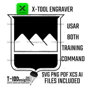 Op de afbeelding: Een zwart-wit grafisch ontwerp met de tekst "X-TOOL ENGRAVER" en "USAR 80TH TRAINING COMMAND". Het ontwerp bevat een schildvorm met bergsilhouetten en een parachute. De afbeelding bevat ook de tekst "SVG PNG PDF XCS AI FILES INCLUDED".