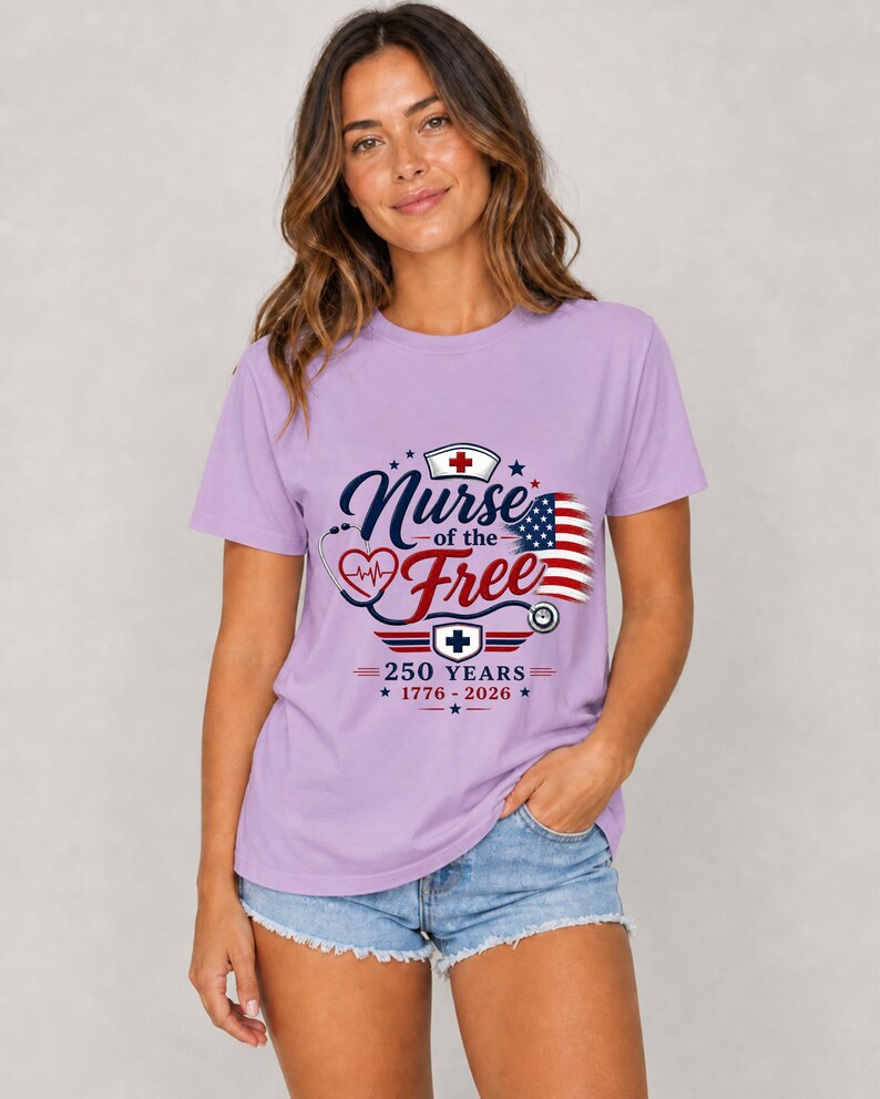 May include: A lilac-colored t-shirt with the text "Nurse of the Free" in navy blue script, featuring a heart, stethoscope, and American flag design. The shirt also includes the text "250 YEARS 1776-2026".