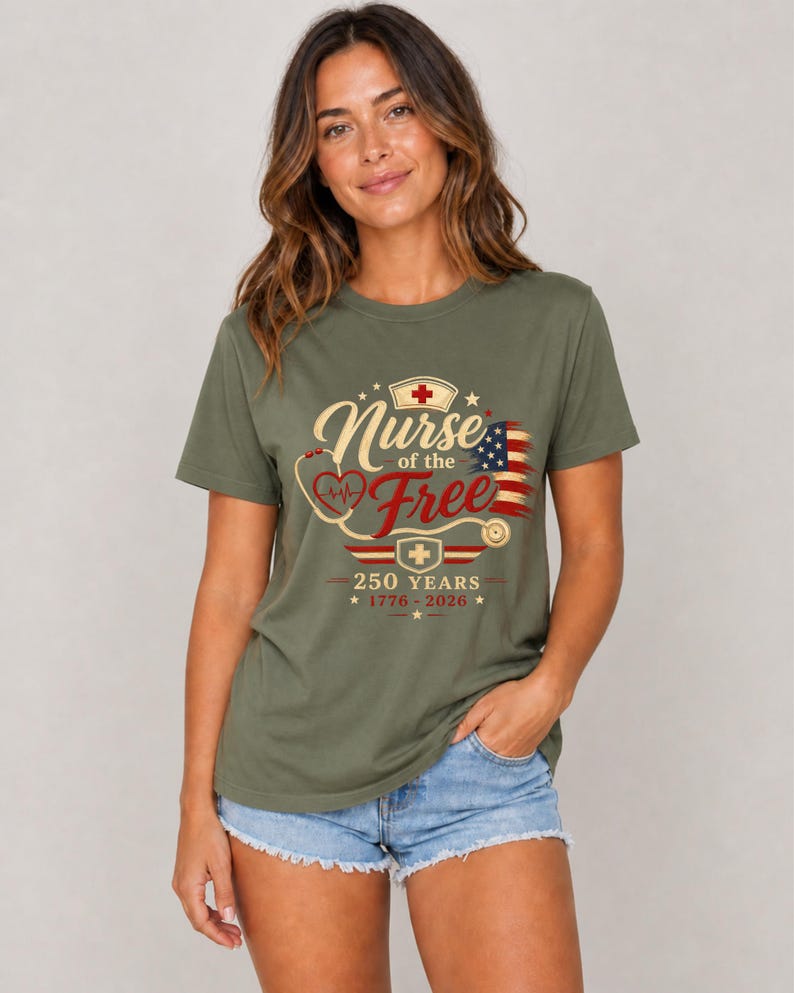 May include: Olive green t-shirt with the text "Nurse of the Free" in a vintage design, featuring a stethoscope, a nurse's cap, and an American flag. The shirt also includes the text "250 YEARS 1776-2026".