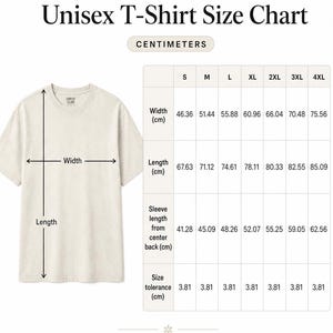 May include: A cream-colored Comfort Colors 1717 unisex t-shirt with a size chart. The chart displays measurements in centimeters for width, length, and sleeve length, ranging from size S to 4XL. The text reads "Measurements are in centimeters."