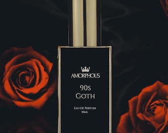 May include: A black glass bottle of perfume with a gold cap and label. The label reads "AMORPHOUS 90s GOTH EAU DE PARFUM 50ML".