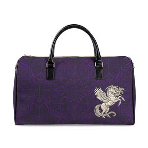 May include: A purple travel bag with a black handle and a gold zip. The bag has a repeating pattern and a white Pegasus design. It includes a shoulder strap and is designed for travel.
