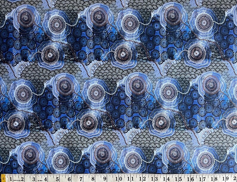 "Authentic Blue Water Dreaming Aboriginal fabric by Tamay Beam, featuring intricate saltwater coastal iconography and dot art in shades of indigo, sky blue, and grey on 100% cotton poplin."