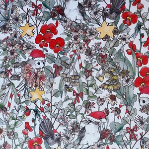 May include: A white background with a repeating pattern of red flowers, green leaves, yellow stars, and birds wearing Santa hats. The birds are perched on branches and some are holding candy canes.