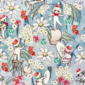 May include: A blue and white Christmas wrapping paper with a repeating pattern of  babies wearing Santa hats, flowers, and Christmas ornaments.