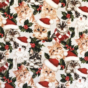 May include: A white fabric with a repeating pattern of kittens wearing Santa hats and holly sprigs. The kittens are in various poses, some sitting, some standing, and some looking at the viewer. The fabric is perfect for crafting projects, such as making holiday decorations, pillows, or quilts.