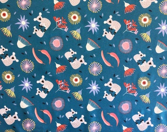 May include: Teal fabric with a repeating pattern of koalas, flowers, and leaves. The koalas are gray and white, the flowers are yellow, orange, and purple, and the leaves are black. The overall design is whimsical and nature-themed.