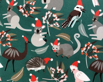 May include: A green fabric with a repeating pattern of Australian animals wearing Santa hats. The animals include a koala, echidna, kookaburra, wombat, emu, and a cockatoo.