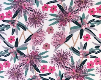 May include: A white fabric featuring a repeating botanical pattern of spiky magenta and purple bottlebrush flowers, small pink five-petaled blossoms, and dark green leaves arranged on thin tan stems across the entire surface.