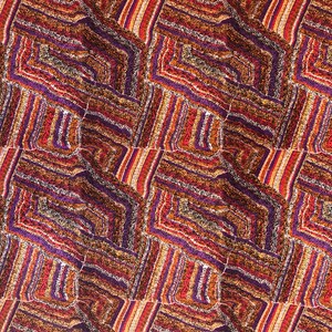 "Vibrant Aboriginal art quilting cotton fabric featuring the 'Mina Mina Dreaming' design by artist Polly Anne Napangardi Dixon. The intricate pattern displays a mosaic of colorful dots in shades of purple, red, orange, and yellow, forming textured geometric paths and ancestral tracks."