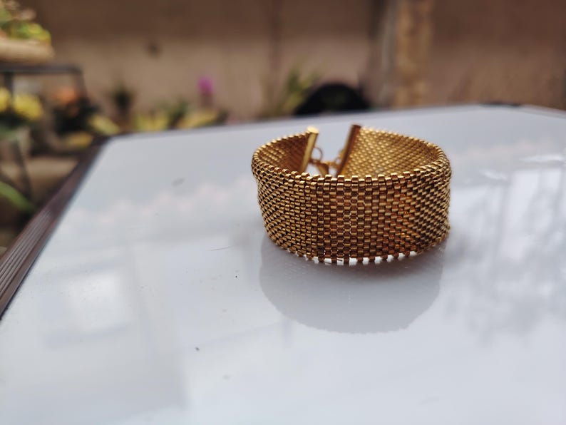 miyuki gold bead cuff, handmade woven bracelet gift, luxury gold mesh wristband, artisanal seed bead cuff, elegant adjustable bracelet, metallic gold beaded band, statement handmade jewelry