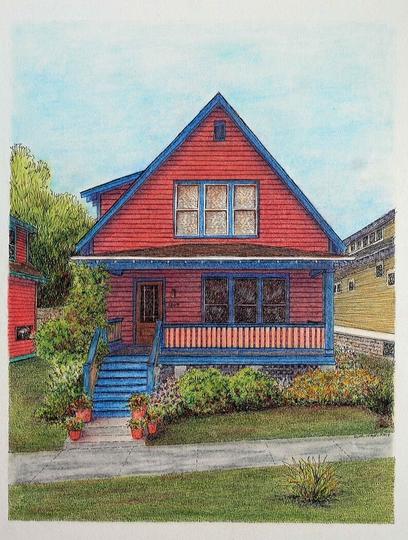 May include: A red house with a blue roof and white trim. The house has a porch with a blue railing and a white picket fence. There are green bushes and flowers in front of the house.
