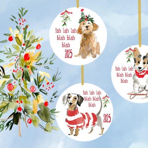 May include: Watercolor Christmas ornaments featuring dogs. Each ornament has a dog illustration, the text "fah lah lah blah blah blah", and the year 2025. The dogs are a goldendoodle, a corgi, and a dachshund.