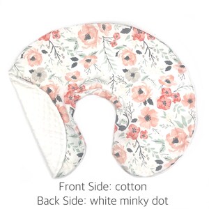 May include: A white and pink floral print nursing pillow with a white minky dot back.  Front Side: cotton. Back Side: white minky dot.