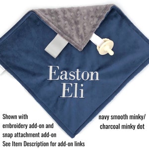 May include: A navy blue and charcoal gray minky baby blanket with the names "Easton Eli" embroidered in white.