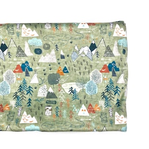May include: Green fabric with a repeating pattern of mountains, trees, and geometric shapes in shades of blue, orange, and brown. The fabric has a textured surface.